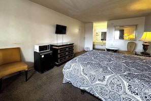 Desk, iron/ironing board, bed sheets