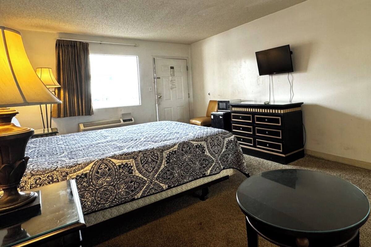 Desk, iron/ironing board, bed sheets