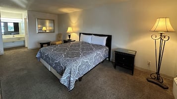 Desk, iron/ironing board, bed sheets