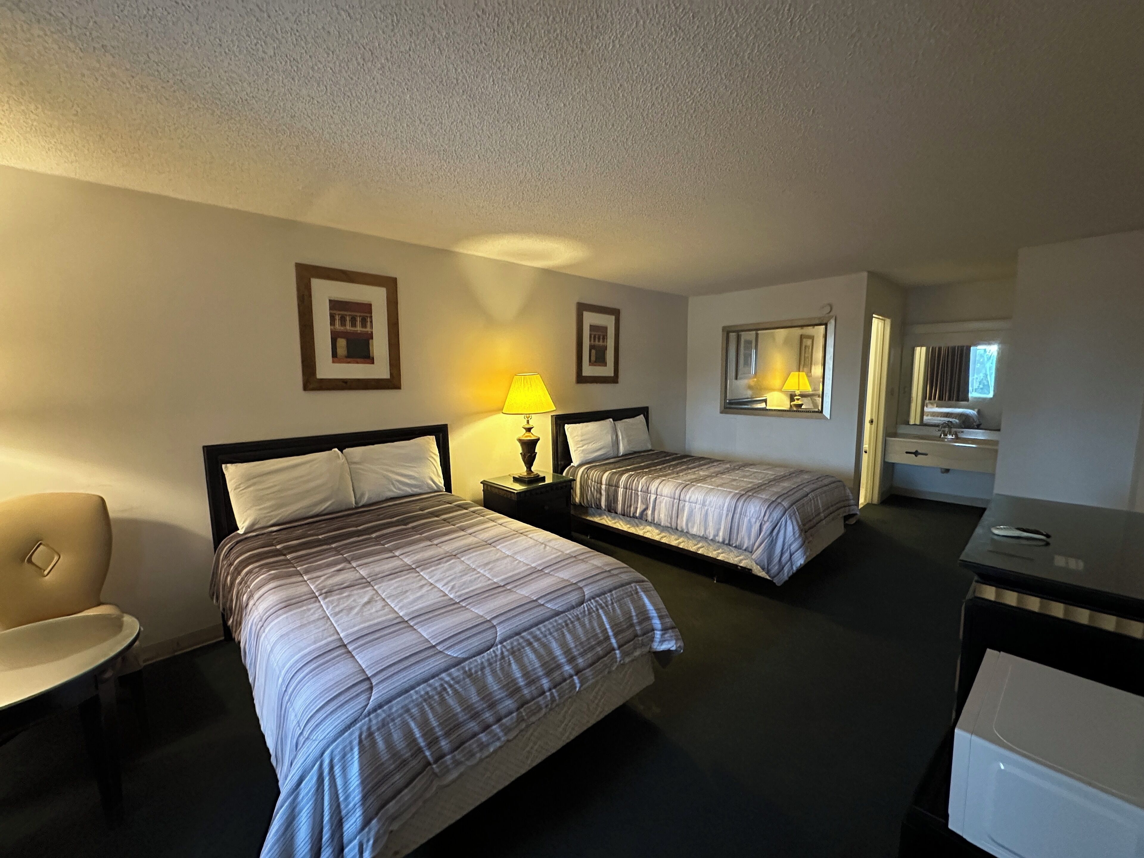 Desk, iron/ironing board, bed sheets