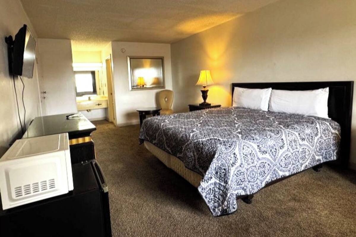 Desk, iron/ironing board, bed sheets