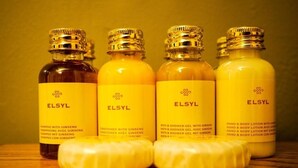 Four ELSYL bottles with labels and a bar of soap.