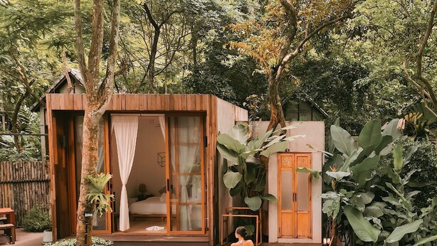 A wooden cabin with a glass door, a small pool, and lush greenery surrounding it. - Proud Phu Fah Maerim (Mae Rim)