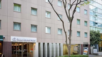 A Daiwa Roynet Hotel with a modern facade, multiple windows, and a visible entrance.