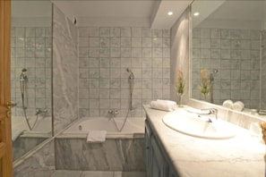 Enjoy a relaxing soak in the bathtub or refreshing shower, surrounded by clean lines and a minimalist design.
