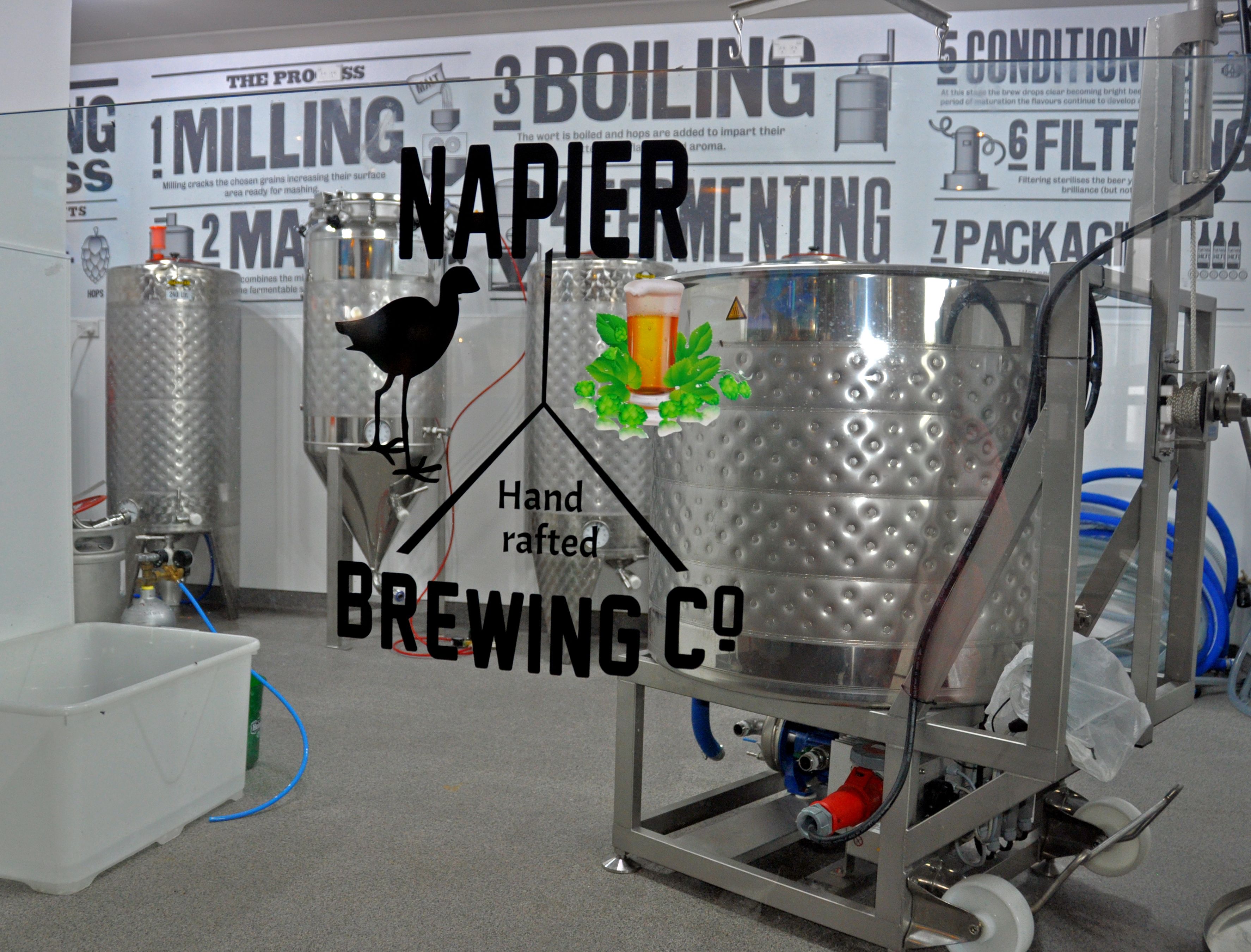 A brewing setup with a tap, a bird figurine, and a hand-rafted brewing container.