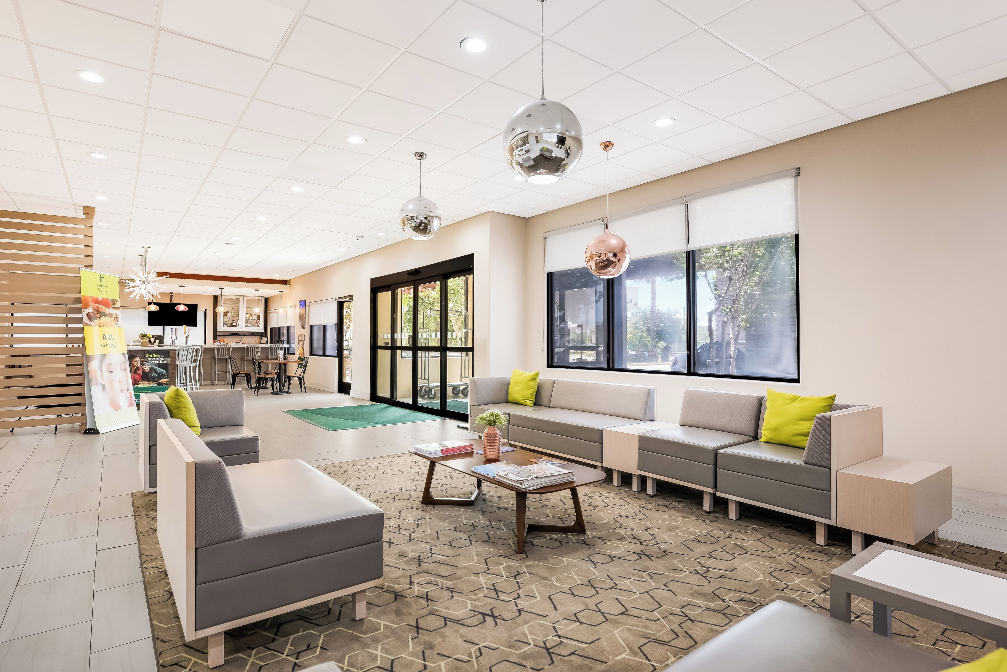 A modern lounge area with seating, a coffee table, and a view of the outside.