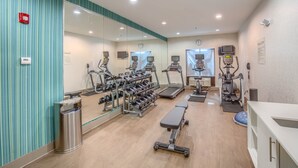 A gym with treadmills, elliptical machines, and weight racks. - Holiday Inn Express & Suites Gulf Shores by IHG (Gulf Shores)