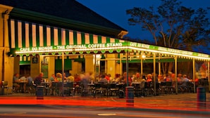 A cafe with outdoor seating and a green and white striped awning. - Express Inn and Suites (Westwego)