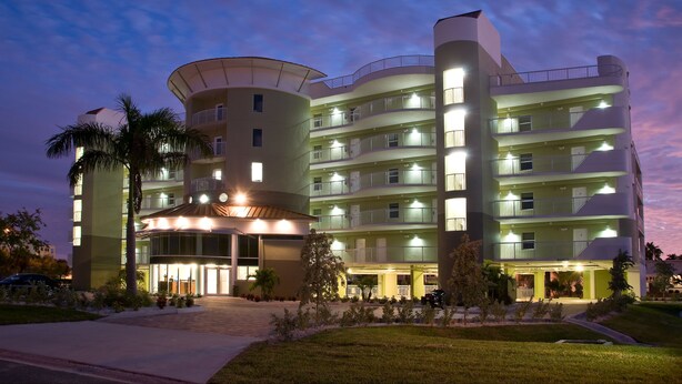 A multi-story hotel with a curved entrance and balconies on each floor.