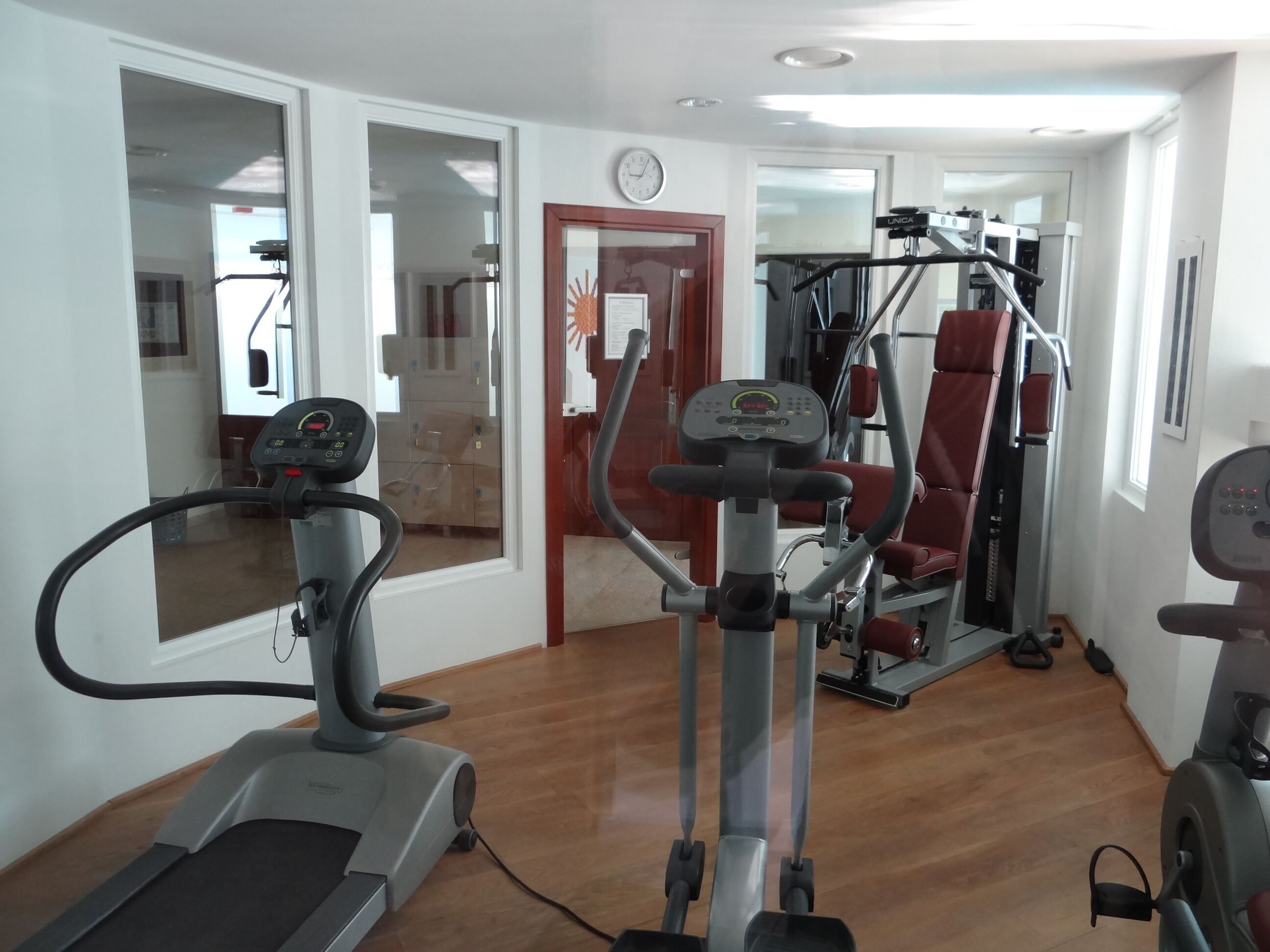 A gym with treadmills, elliptical machines, and weight machines.