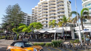 A modern building with multiple balconies and a covered outdoor seating area. - Mantra Zanzibar (Mooloolaba)