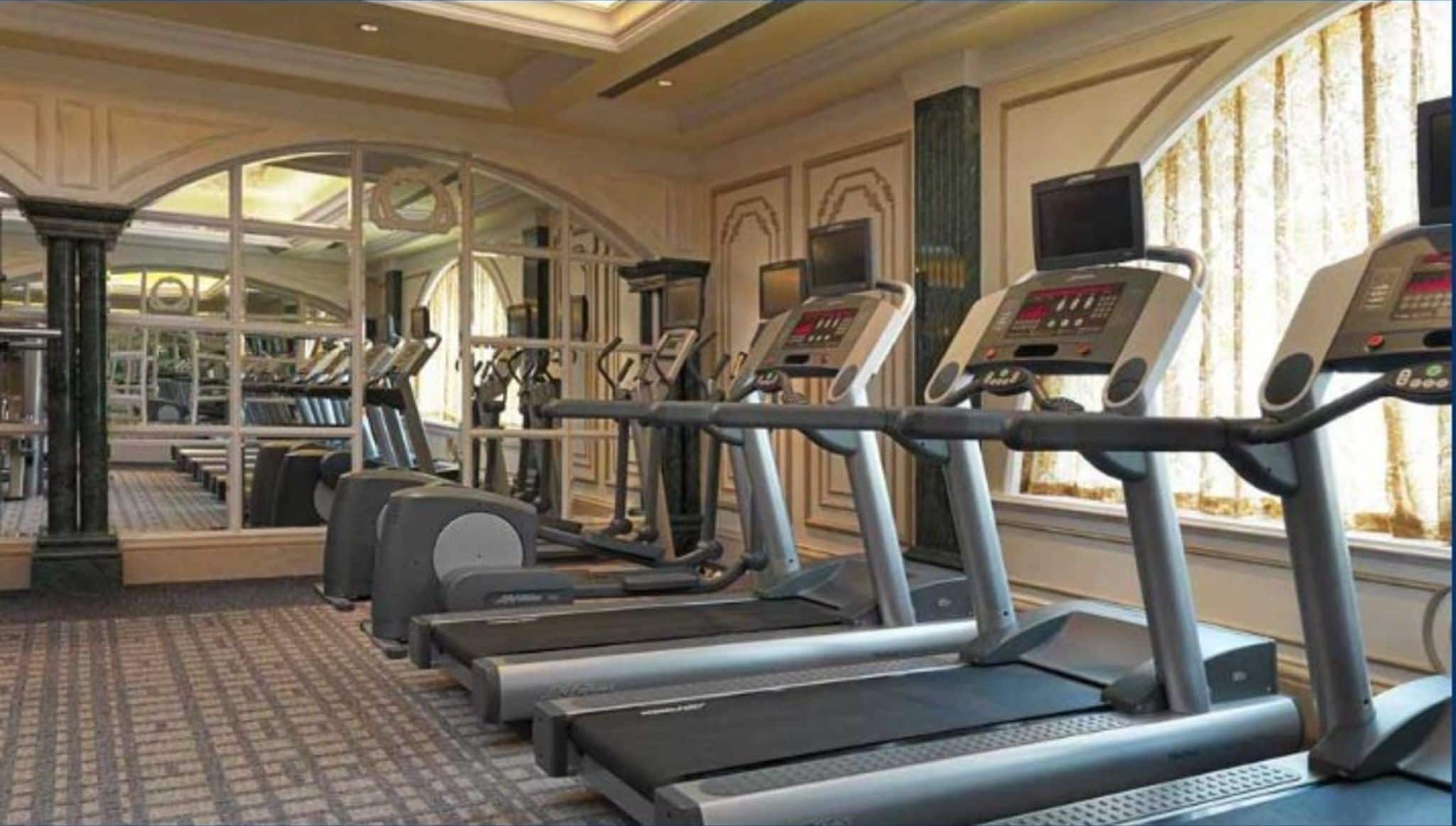 A gym with treadmills, exercise bikes, and weight machines.