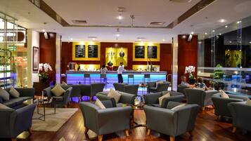 A modern lounge area with sofas and a bar counter.