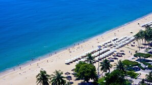 An aerial view of a beach with rows of umbrellas and palm trees. - Novotel Nha Trang (Nha Trang)