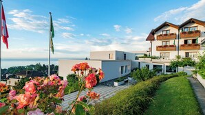 Un bâtiment moderne doté de balcons, un ciel dégagé et une vue sur la mer.