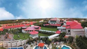 A resort with multiple buildings, a swimming pool, and a playground. - Celestia Suites at Leonia (Shamirpet)