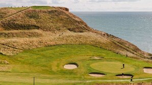 A coastal golf course with bunkers and a view of the sea. - Eype's Mouth Country Hotel (Bridport)