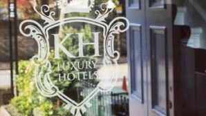 A glass door with the text "XII LUXURY HOTELS" and "EDINBURGH REGENCY GUEST HOUSE" visible.