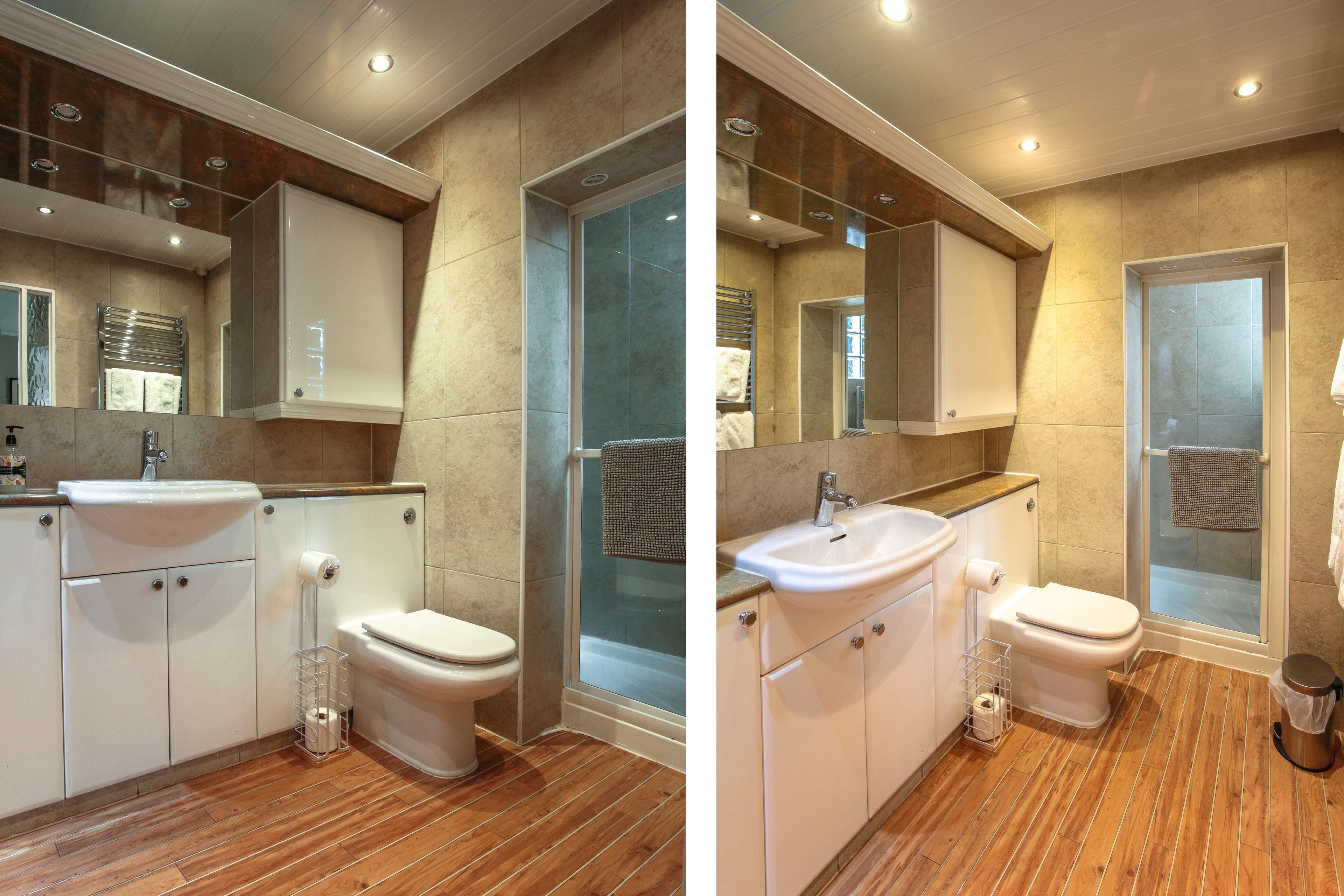 Un baño moderno con ducha, inodoro, lavamanos y armarios.