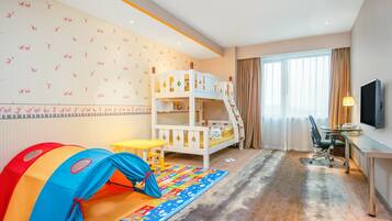 Cozy space for kids, featuring a bunk bed, play tent, desk, and TV.