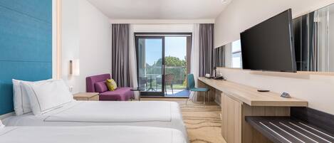 A hotel room with two beds, a desk, a TV, and a balcony with a view.
