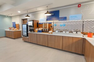 A modern breakfast area with a self-serve station, a digital menu board, and a clean, minimalist design.