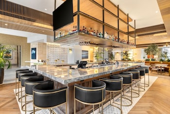 A modern living room with a fireplace, a large flat-screen TV, and a sofa. at The Moran CITYCENTRE