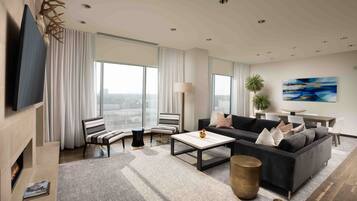 A modern living room with a fireplace, a sofa, a coffee table, and a TV.