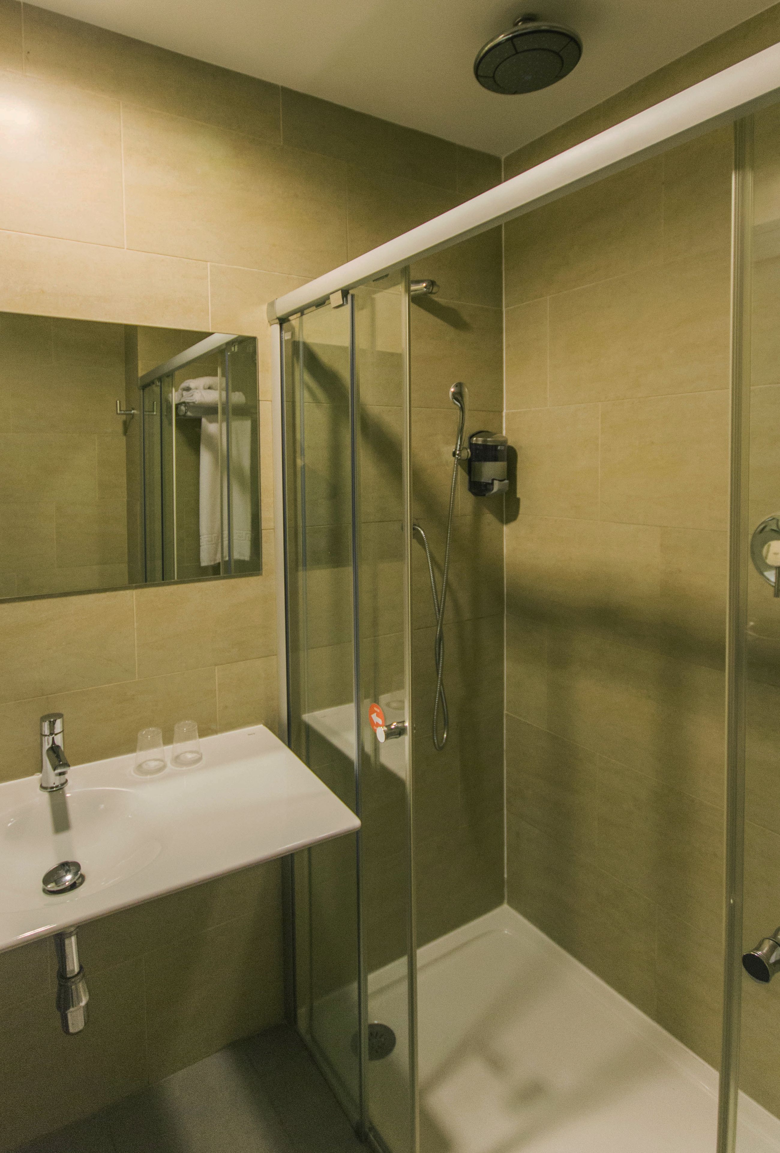 shower, rainfall showerhead, hair dryer, towels