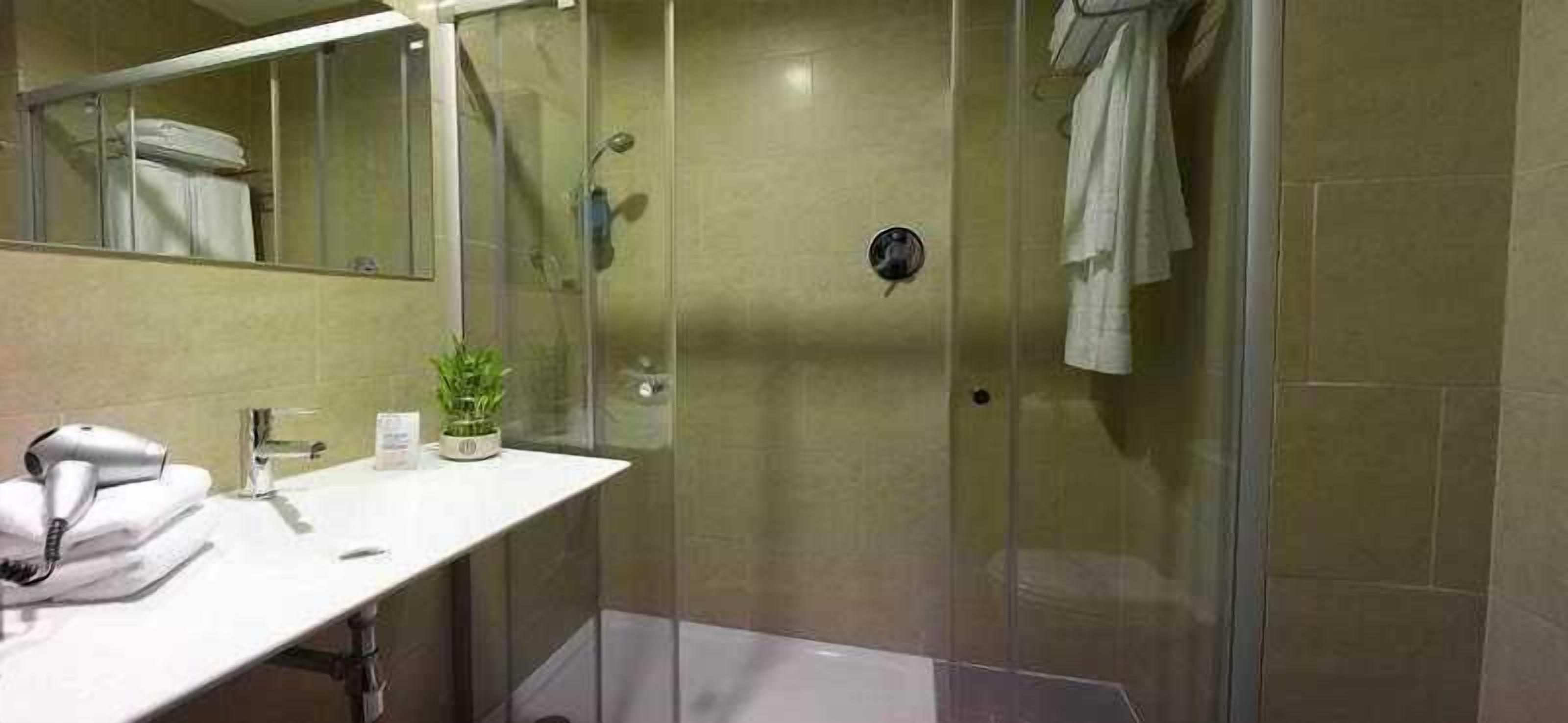 shower, rainfall showerhead, hair dryer, towels