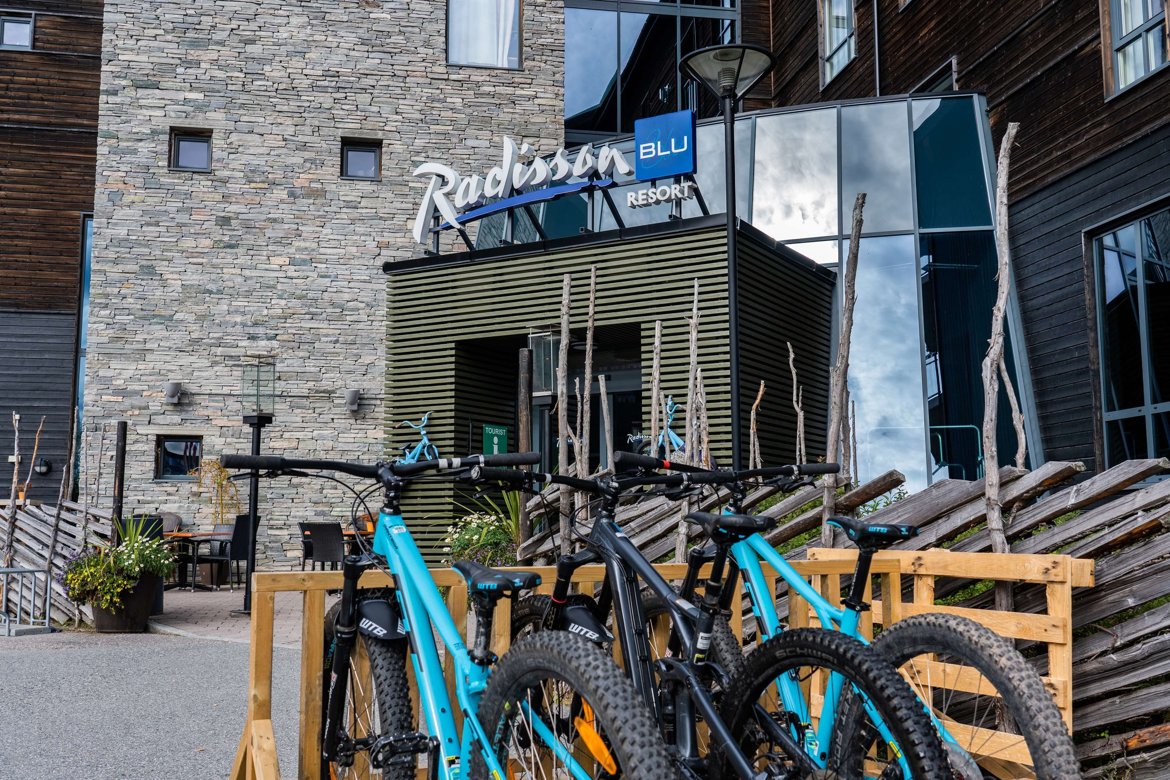 A building with a stone facade and a sign that reads "Radisson BLU RESORT".