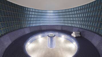 Relax in a hot tub surrounded by a circular seating area.