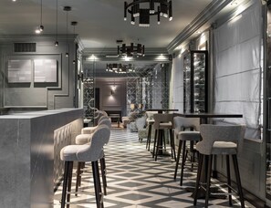 A modern bar area with bar stools, a marble countertop, and a patterned floor. - Heritage hotel Bastion (Zadar)