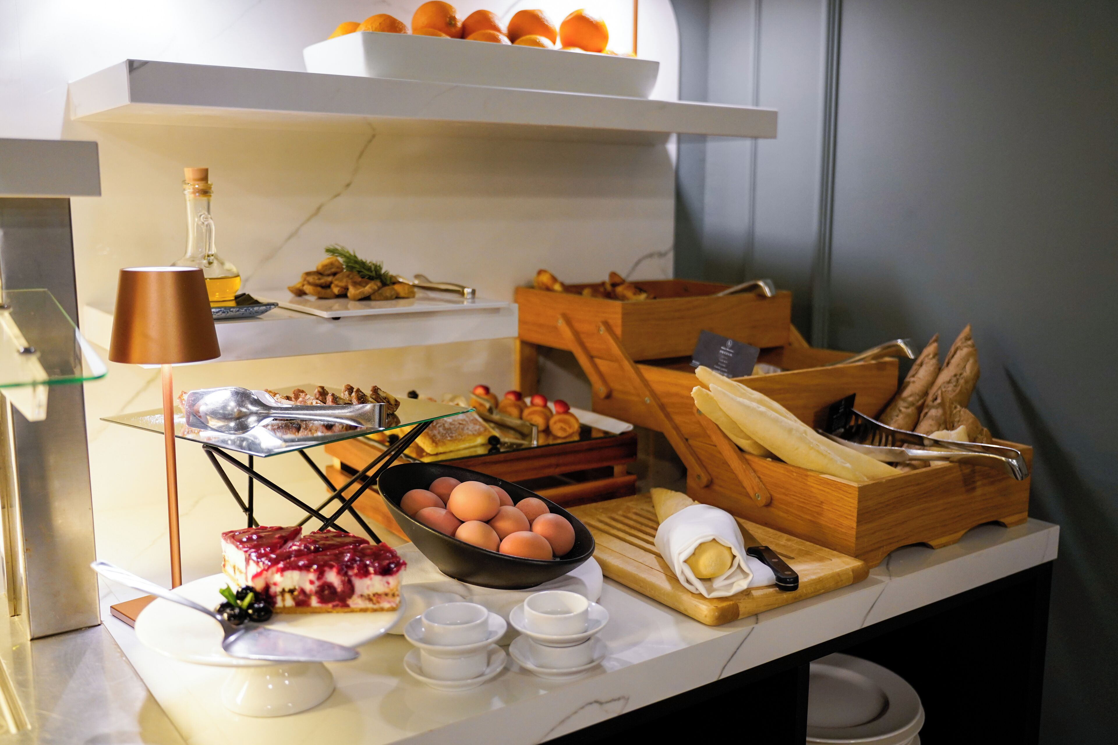 A breakfast buffet with various food items and utensils.