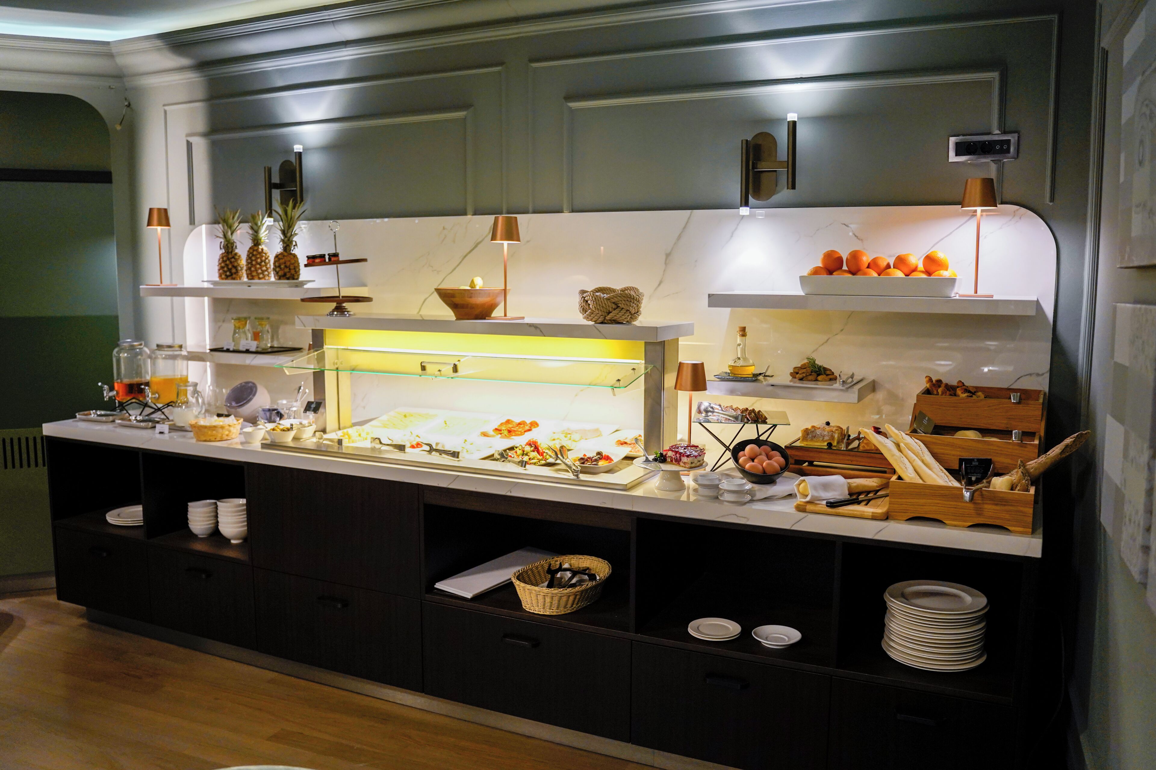 A buffet setup with various food items and utensils.