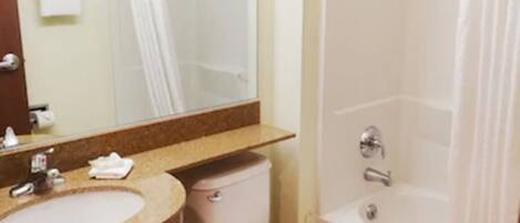 A bathroom with a sink, toilet, and bathtub.