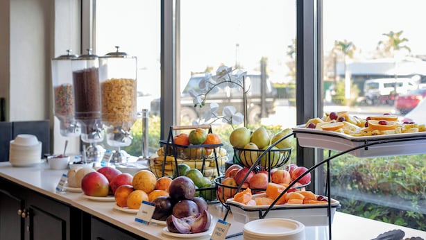 A breakfast buffet with various fruits and cereals. - Holiday Inn Express San Jose Costa Rica Airport by IHG (Rio Segundo)