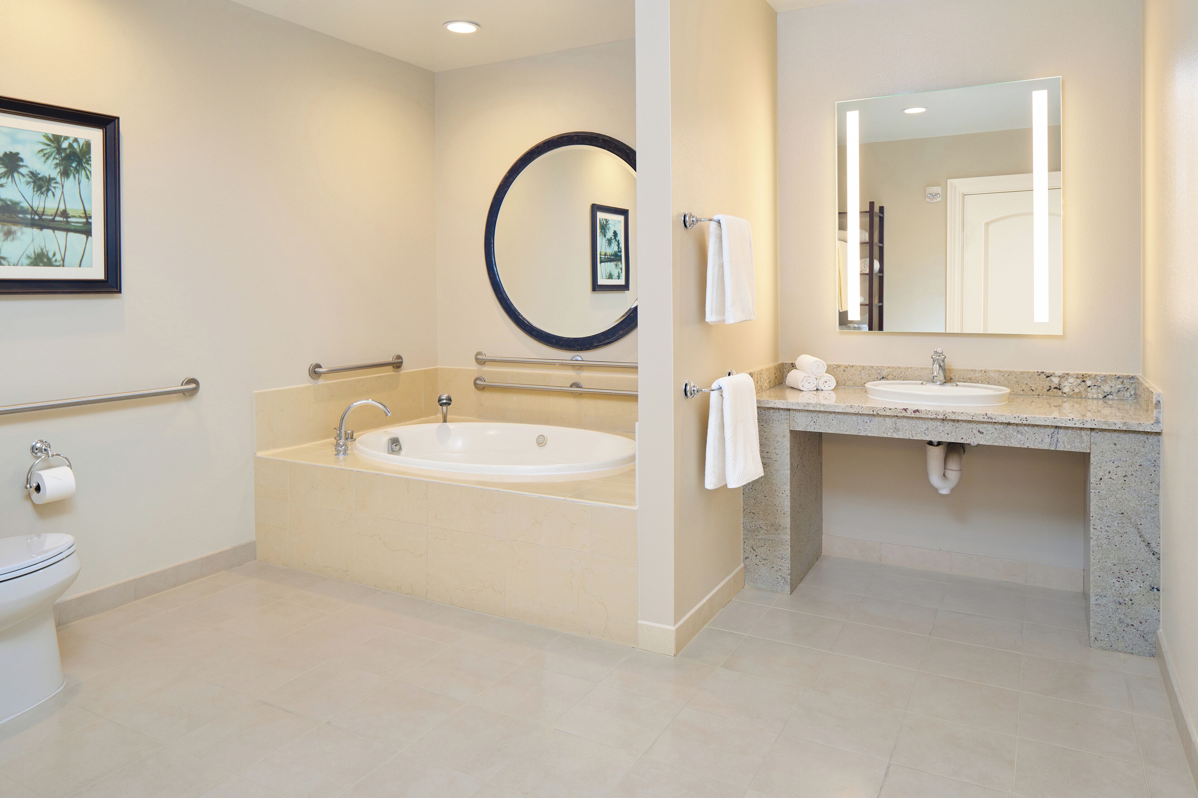 A modern bathroom with a bathtub, a sink, and a toilet.
