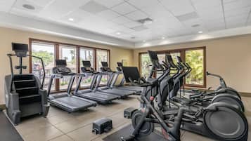 A gym with multiple treadmills, a stair climber, and exercise equipment.