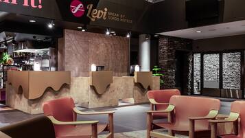 A modern reception area with a Levi logo, a stone wall, and a bar area with a plant.
