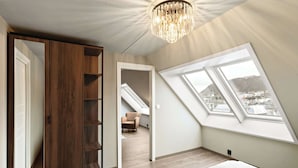Un dormitorio con tragaluz, un armario y vistas a la ciudad.