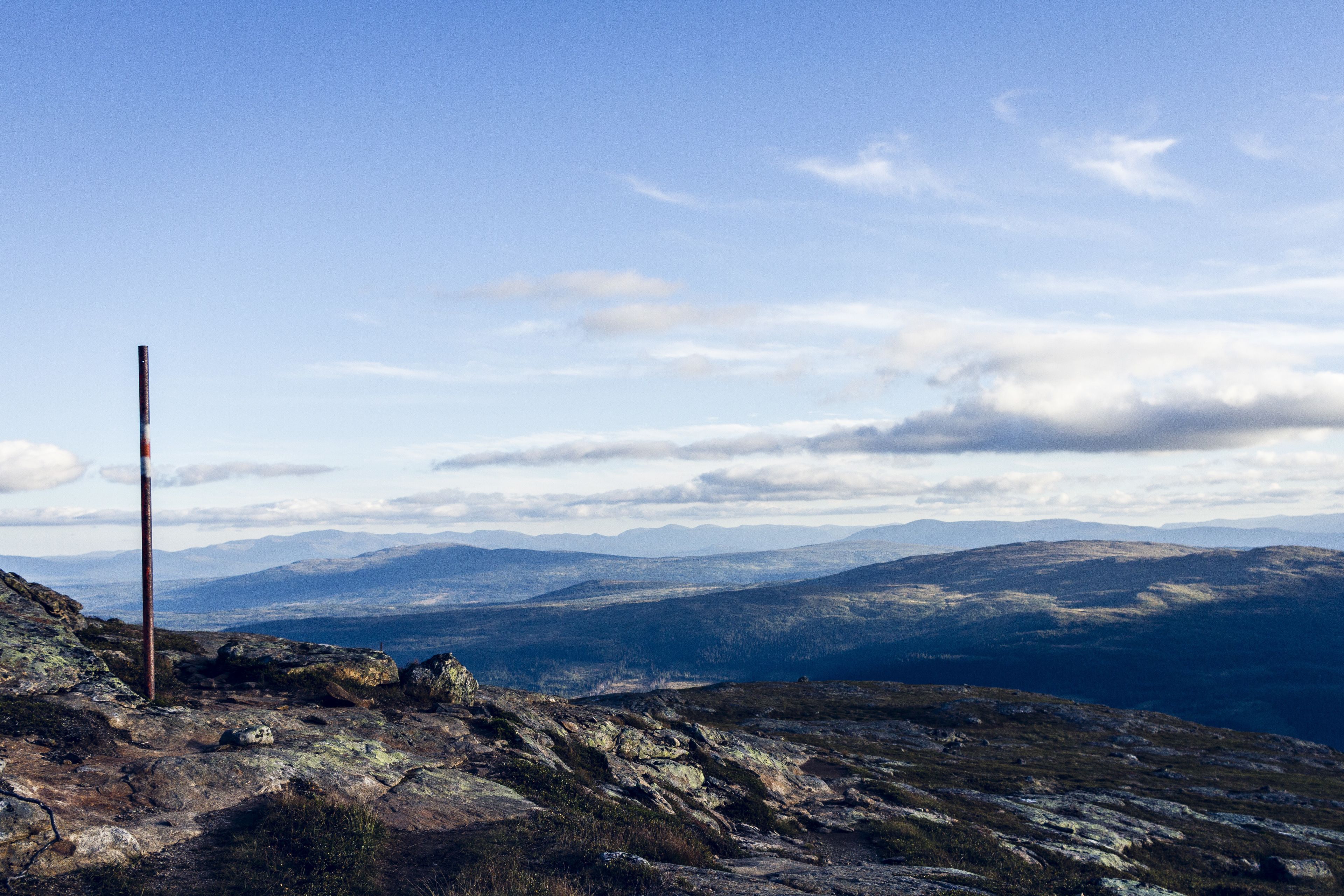 A rocky landscape with a clear sky and distant mountains.