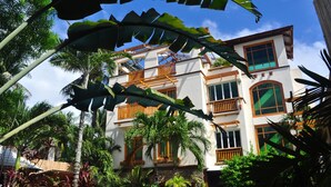 A multi-story building with balconies, surrounded by tropical vegetation. - Boracay Beach Club (Boracay Island)