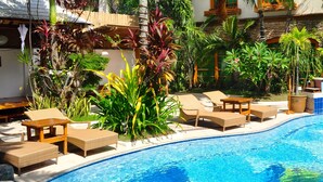 A poolside area with lounge chairs and a swimming pool. - Boracay Beach Club (Boracay Island)