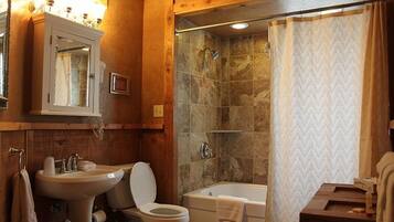 Une salle de bain avec un lavabo, des toilettes et une baignoire.