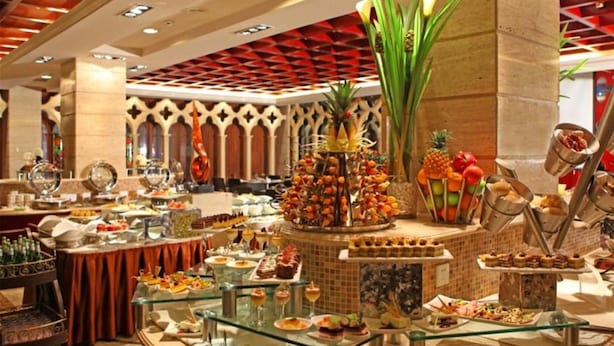 A buffet setup with various food items and a decorative centerpiece. - Dalian East Hotel (Dalian)
