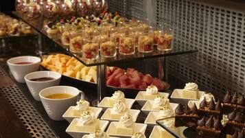 A buffet with various desserts and beverages.