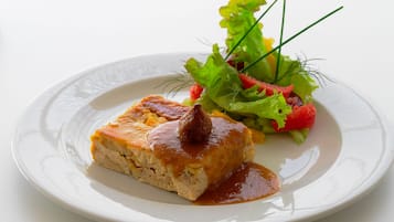 A plate with a piece of food and a side salad.