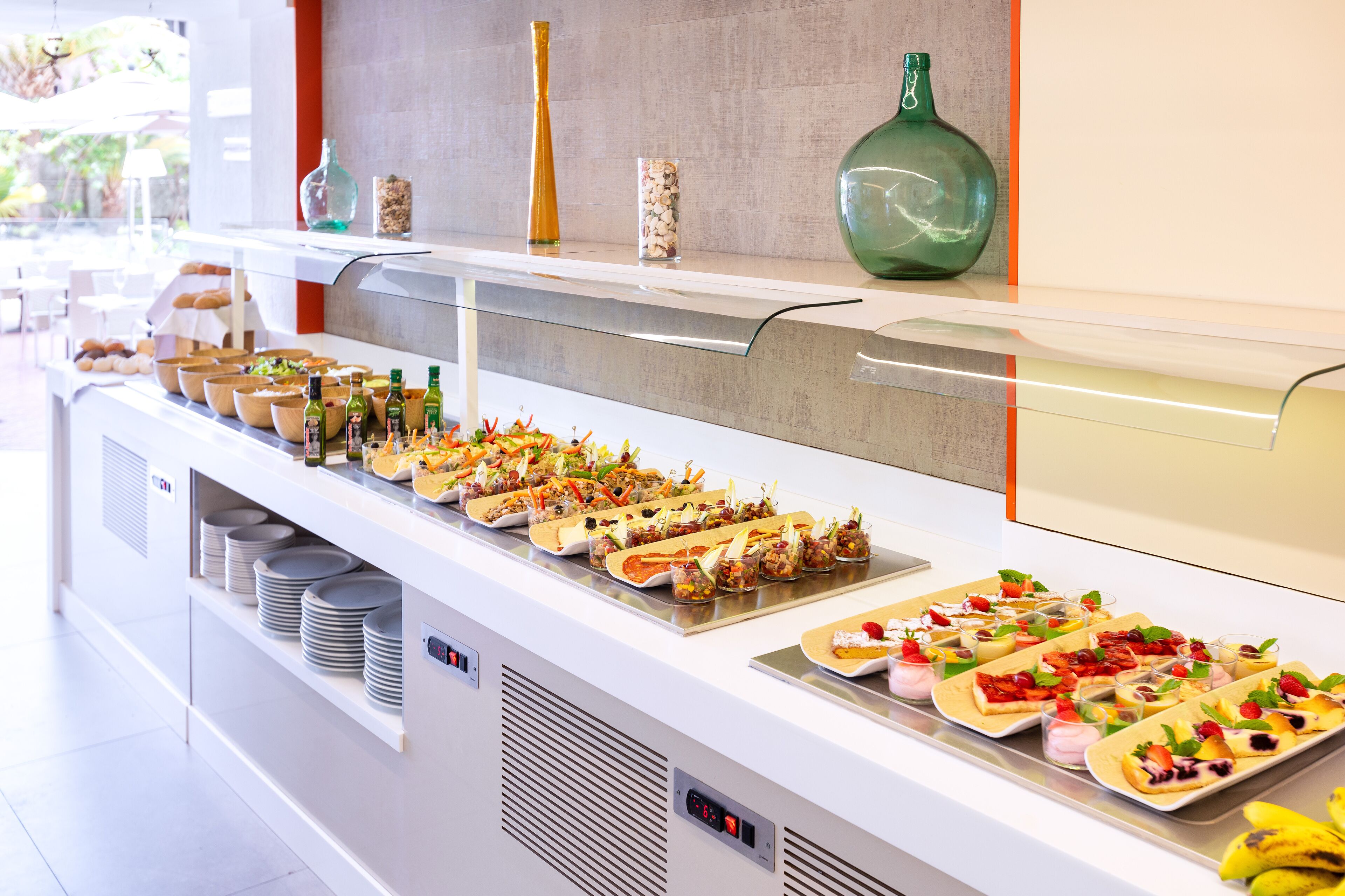 A buffet with various food items and condiments.